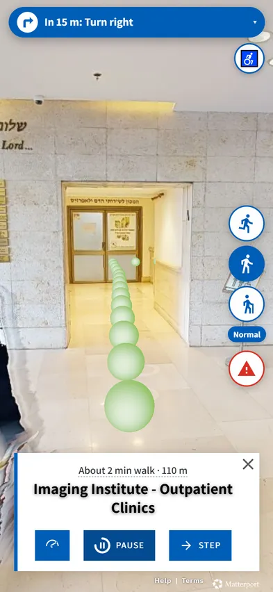 Hospital corridor with the route on the floor, the instruction In 15 m: Turn right and 110 metres left